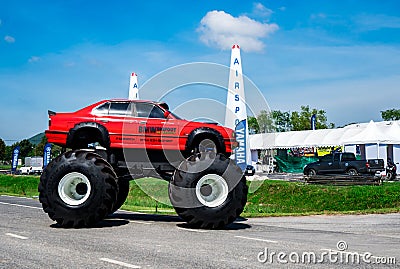 Red BMW car 4x4 bigfoot parked on asphalt road in Air Race 1 World Cup Thailand 2017 at U-Tapao Naval Air Base Editorial Stock Photo