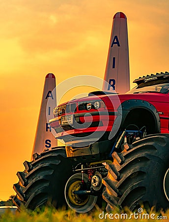Red BMW car 4x4 bigfoot parked on green grass in Air Race 1 World Cup Thailand 2017 at U-Tapao Naval Air Base Editorial Stock Photo
