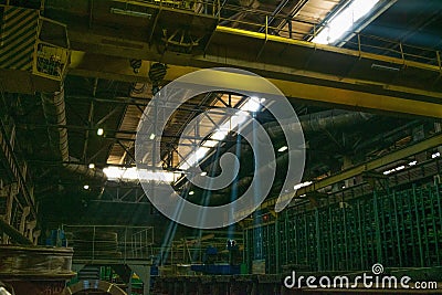 Rays of light in a dark industrial workshop of an industrial plant. Warehouse of heavymetal Stock Photo