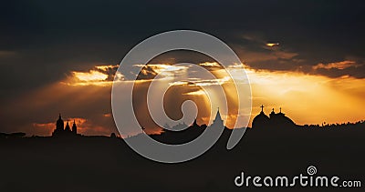 Rays of light shining through dark clouds over Jerusalem city. Christian Religion concept background Stock Photo