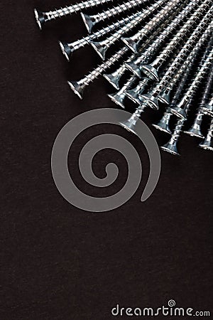 Rays-shaped Self-tapping screw on black background. Stock Photo