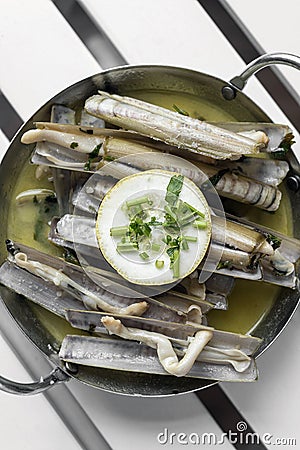 Razor clams sauteed with garlic butter white wine in spain Stock Photo