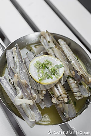 Razor clams sauteed with garlic butter white wine in spain Stock Photo