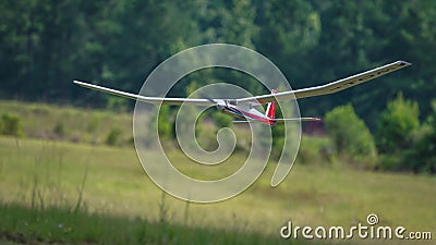 RC Model Glider Flying over Runway Stock Photo