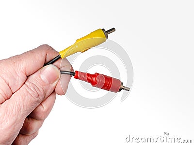 RCA connector in the hand. Audio and video wire Stock Photo