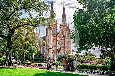 Facade view of St. Mary`s Cathedral from Hyde park with trees framing the building in Sydney NSW Australia Editorial Stock Photo