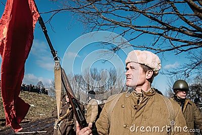 Re-enactor Dressed As Russian Soviet Infantry Soldier Of World War II Holding Red Flag Editorial Stock Photo