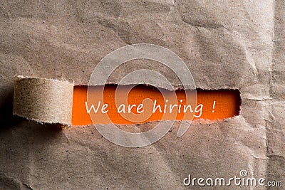 We`re Hiring, the phrase is written on orange paper in torn envelope, Human resource concept, strategy, plan, planning. Stock Photo