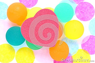 Red heart on Coloured rubber ball on polka dot background Stock Photo