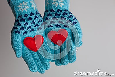 Red hearts in hands in warm gloves for Valentines Day Stock Photo