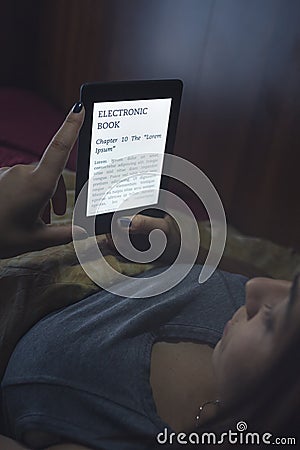 Reading an ebook in bed Stock Photo