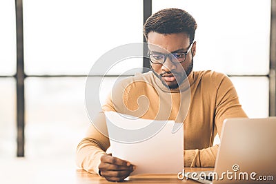 African american manager checking reports in modern office Stock Photo