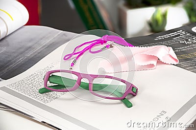 Reading glasses endorsed on a magazine at home Stock Photo