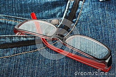 Reading glasses in jeans pocket Stock Photo