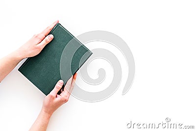 Reading for leasure. Hands take hardback book with empty cover on white background top view space for text Stock Photo