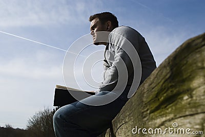 Reading on Log Stock Photo