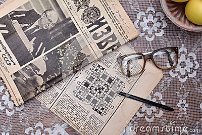 Reading old Soviet newspapers, vintage glasses Editorial Stock Photo