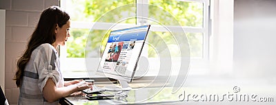 Reading Online News Article On Computer Stock Photo