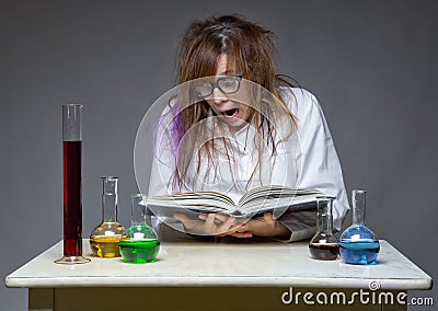 Reading surprised scientist with glass flask Stock Photo