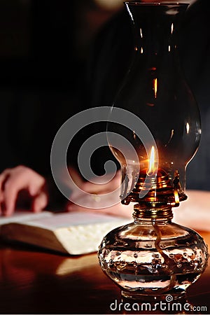 Reading By Vintage Lamplight Stock Photo