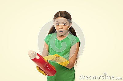 Reading washing instruction for using household cleaning product. Small child holding laundry detergent. Cute cleaner Stock Photo