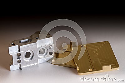 Ready CNC golden and silver metal detail on white background with shadow Stock Photo