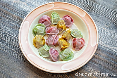 Ready colorful dumplings. Boiled dumplings on a plate. Pelmeni. Pelmeny. Top view, part of kids menu Stock Photo