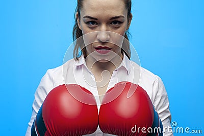 Ready for a fight. Determined business woman wearing boxing gloves. Stock Photo