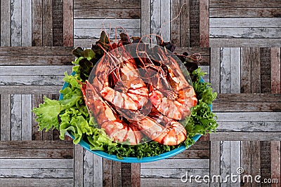 Grilled large fresh prawns served with megetables on blue plate Stock Photo