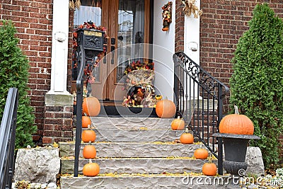 Ready for Halloween: An Assortment of Pumpkins on the Front Steps and Porch of A House Stock Photo