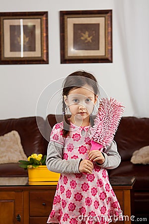 Little girl with feather duster Stock Photo
