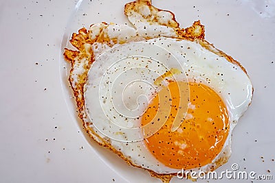 Ready to eat fried egg on plate Stock Photo