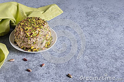 Ready to eat halva, nuts, green napkin and copy space on gray Stock Photo