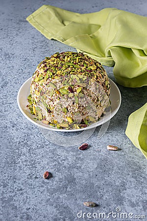 Ready to eat halva, nuts and green napkin on gray Stock Photo