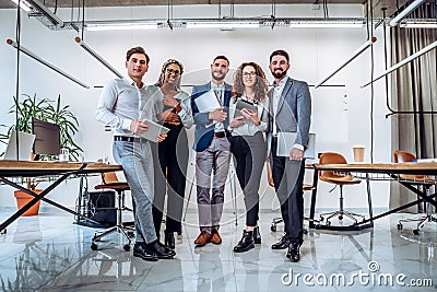 Ready to work. Young business team holds laptops and tablets Stock Photo