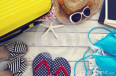 Ready vacation suitcase on wooden background Stock Photo
