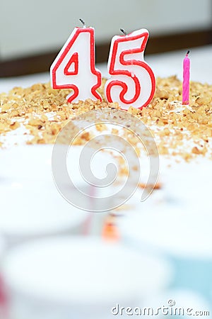 Birthday Cake With Candles, celebrate 45 years old. Handmade cake with candle number 45 and one candle for next year. Stock Photo