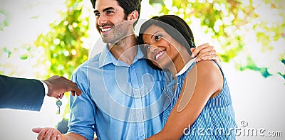 Real estate agent giving house keys to couple Stock Photo