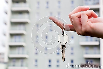 A real estate agent holding keys to a new apartment in her hands. Stock Photo