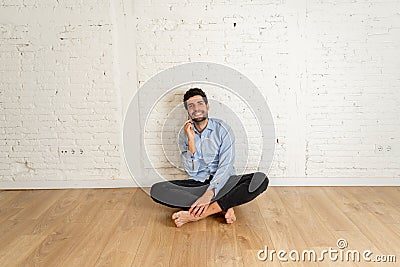 Real estate agent or house hunting man on mobile sitting at his new property investment Stock Photo