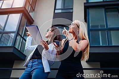 Real estate agent presenting new apartment to client. Businesswoman shows building to customer Stock Photo