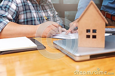 Real estate agent showing his client where he has to sign a contract on sealing deal Stock Photo