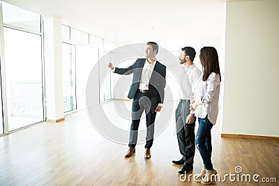 Real Estate Agent Showing New Apartment To Man And Woman Stock Photo