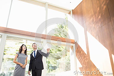 Real-estate agent showing young woman new home Stock Photo