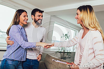 Real Estate agent shows interior to couple Stock Photo