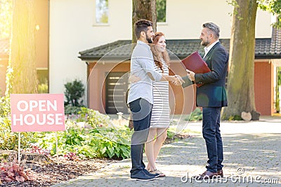 Real estate agent welcoming visitors Stock Photo