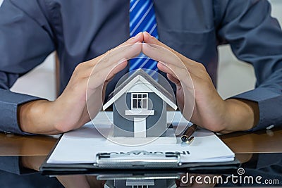 Real estate agents hand prevent home model, explains the business contract for signing a business contract, renting, buying, Stock Photo