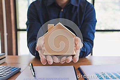 Real Estate broker or sale agent giving consultation to customer about buying house sign agreement document contract. Home loan Stock Photo