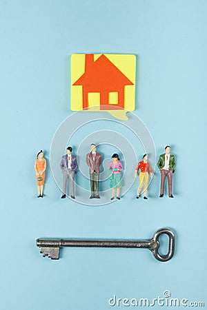 Real Estate concept. Construction building. Blank speech bubbles, people toy figures, paper model house, blueprints with Stock Photo