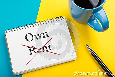 Real estate concept. Notepad with buy or rent message, coffee cup, pen and flower. Office supplies on desk table top Stock Photo